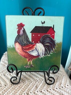 Square tempered glass cutting board with rooster and barn motif